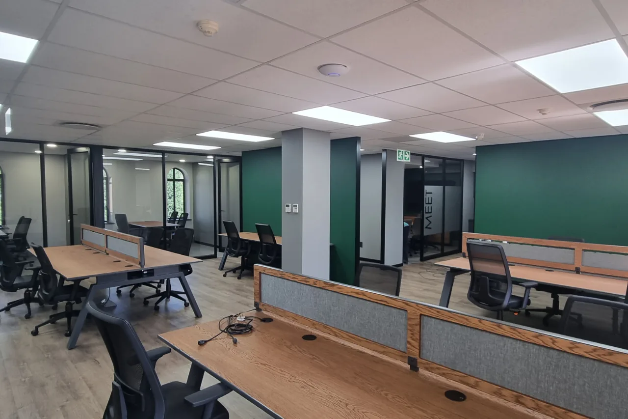 An organized office showcasing desks and chairs, creating a functional workspace for employees.