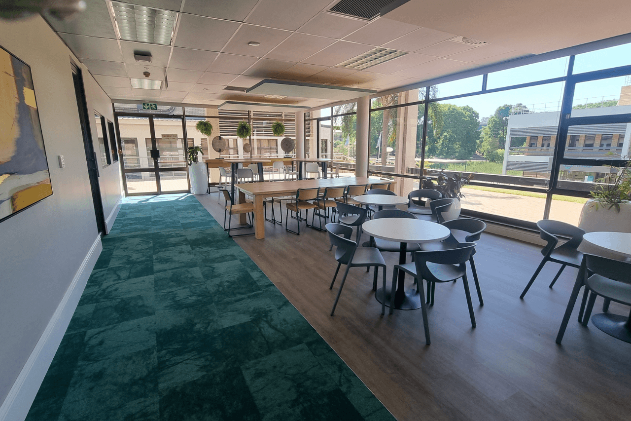 An expansive open space filled with tables and chairs for gatherings.