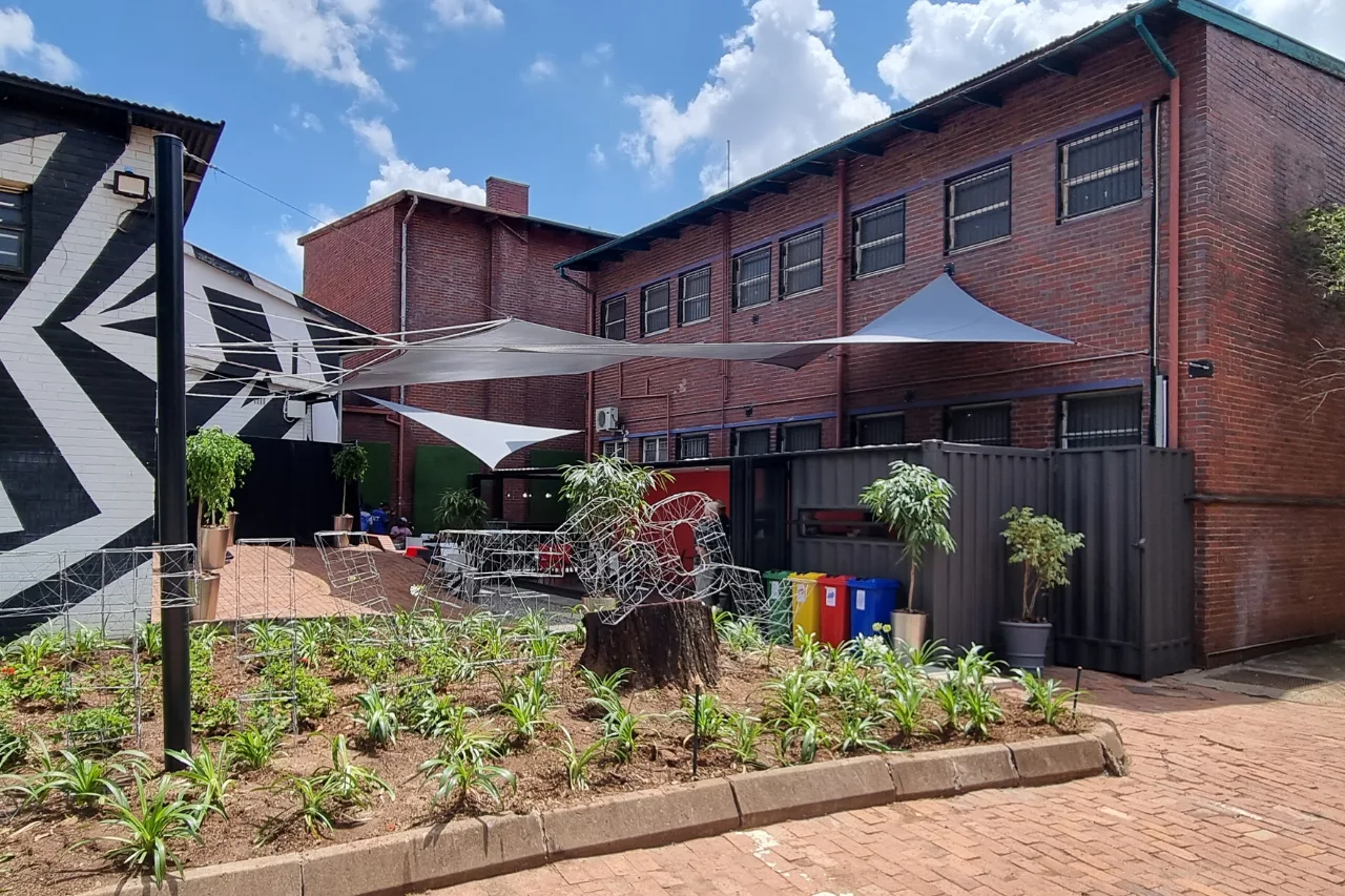 A shipping container converted into a kiosk and sitting area.